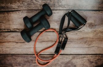 A bright and inviting home workout space with a yoga mat, dumbbells, and a water bottle, emphasizing a beginner-friendly environment.