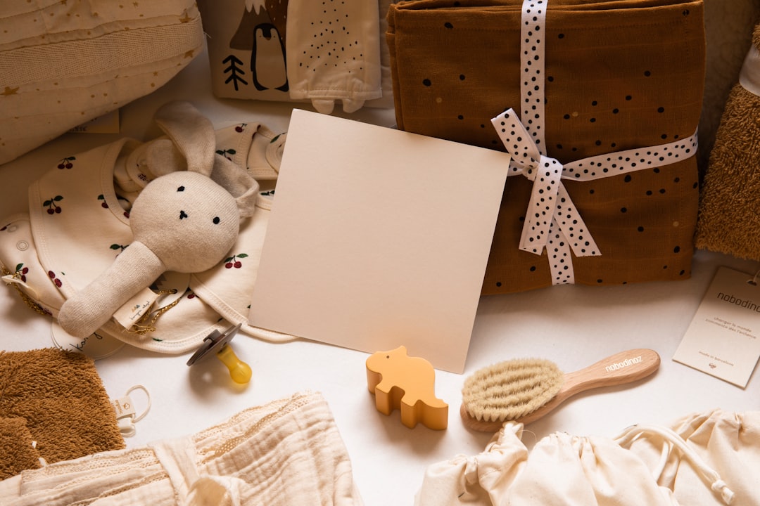 A collection of essential baby care items including diapers, bottles, and toys arranged neatly.