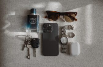 A neatly organized travel essentials kit with various items like a portable charger, travel-sized toiletries, and a compact first aid kit, set against a backdrop of a suitcase and travel accessories.
