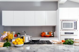 A well-organized kitchen with neatly arranged utensils, clear storage containers, and a clean countertop.